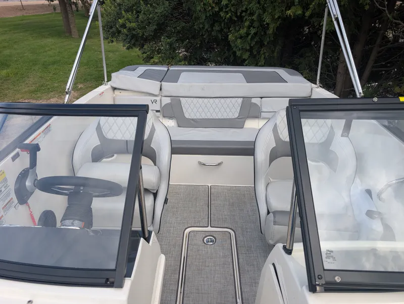 Slide: The Image of The image shows the cockpit of a 2023 Bayliner VR4 Bowrider with gray and white seating. - 18