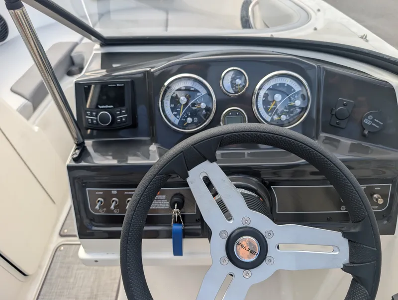 Slide: The Image of The image shows the dashboard of a Bayliner VR4 Bowrider with modern instruments and a steering wheel. - 13