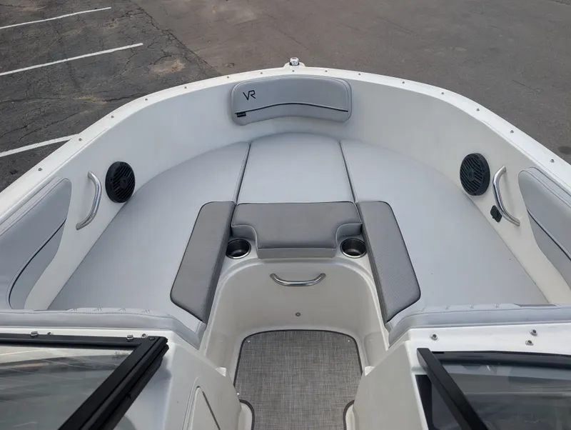 Slide: The Image of The image shows the bow area of a 2023 Bayliner VR4 Bowrider with gray upholstery. - 17