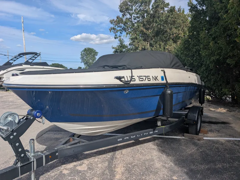 The Image of A 2023 Bayliner VR4 Bowrider on a trailer, featuring blue and white paint. - 0