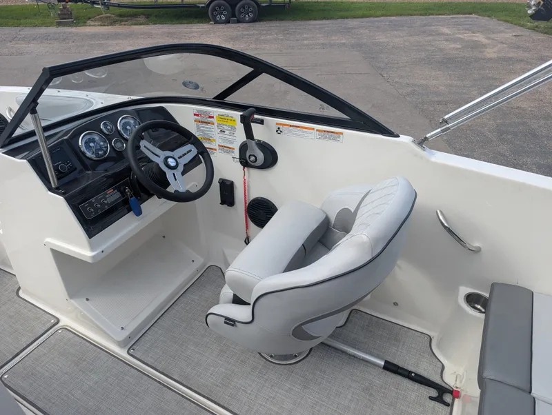 Slide: The Image of The image shows the cockpit of a 2023 Bayliner VR4 Bowrider with a gray seat. - 9