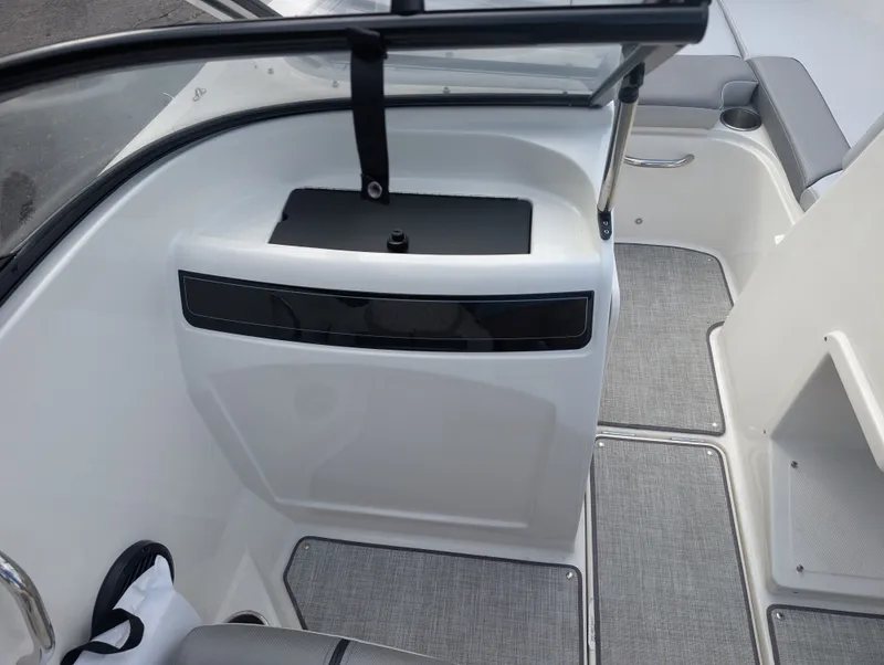 Slide: The Image of The image shows the interior of a 2023 Bayliner VR4 Bowrider with gray flooring. - 16