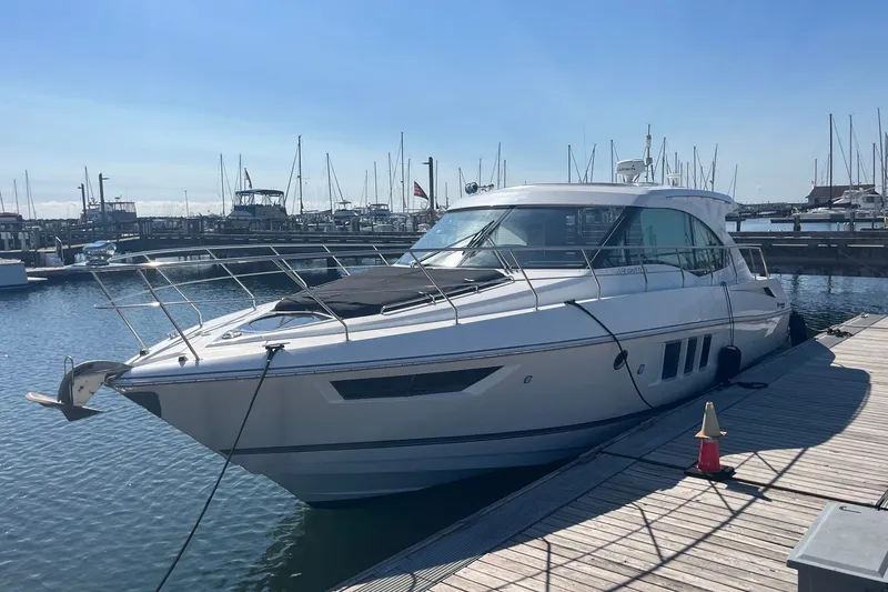 The Image of 2014 Cruisers Yachts 45 Cantius docked at marina under clear blue sky. - 0