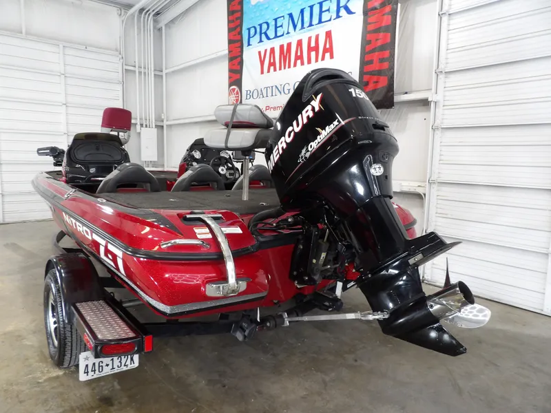 Slide: The Image of A red 2010 Nitro Z-7 boat with a Mercury outboard motor in a garage. - 10