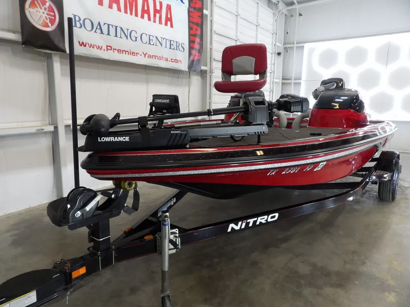 Slide: The Image of A red 2010 Nitro Z-7 boat is in a showroom, mounted on a trailer. - 8