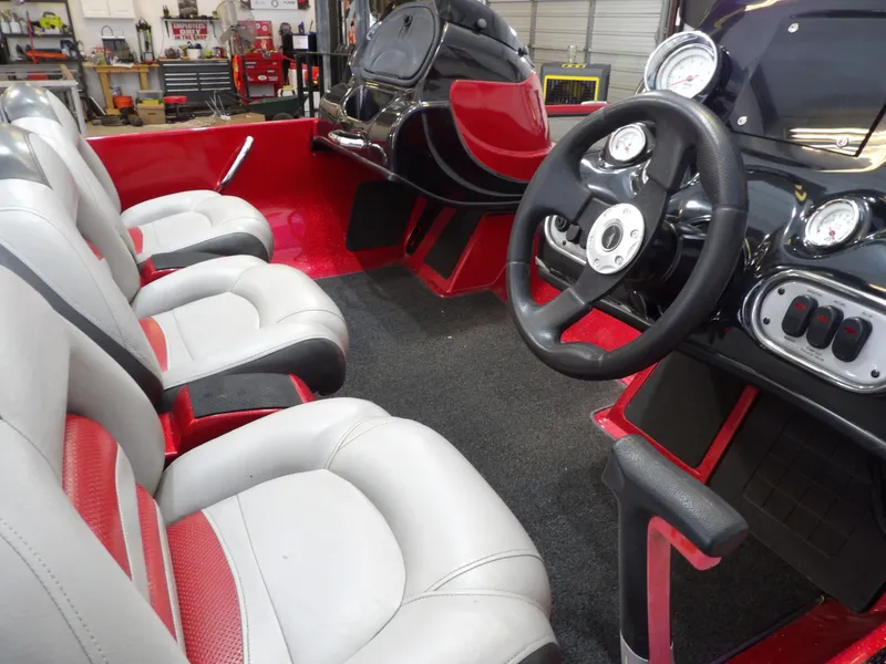Slide: The Image of The image shows the cockpit of a 2010 Nitro Z-7 boat with white and red seats. - 7