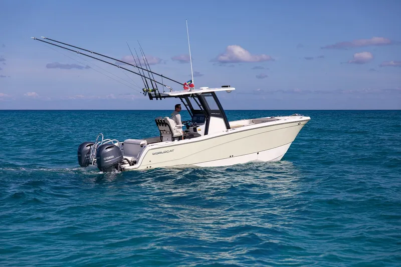 The Image of A 2026 World Cat 265CC boat cruising on calm, blue waters with several fishing rods. - 1