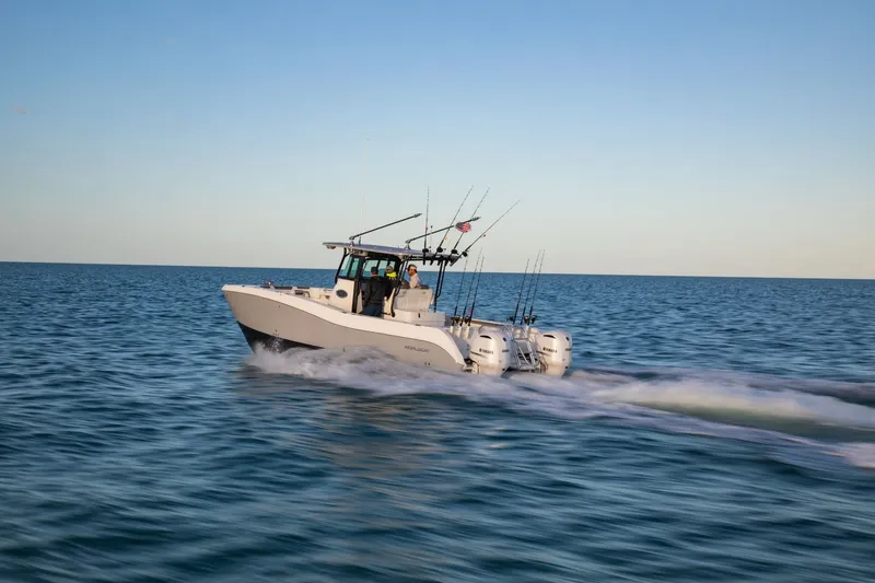 The Image of A 2026 World Cat 325 CC boat speeds across the calm sea. - 1