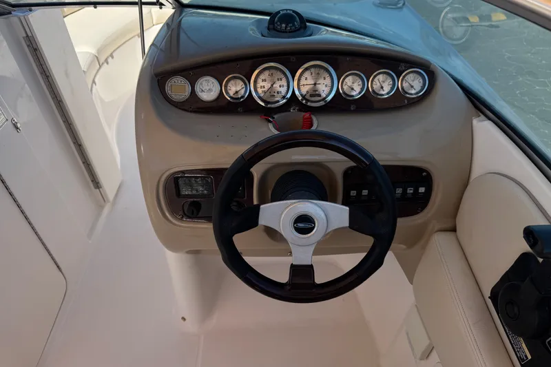 Slide: The Image of 2003 Chaparral Sunesta 263 boat dashboard with steering wheel and instrument panel. - 34