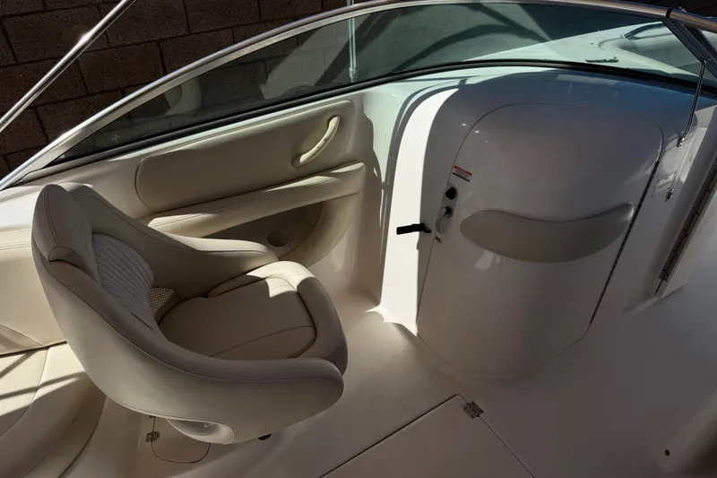 Slide: The Image of Interior of 2003 Chaparral Sunesta 263 boat, featuring a sleek white captain's chair. - 28