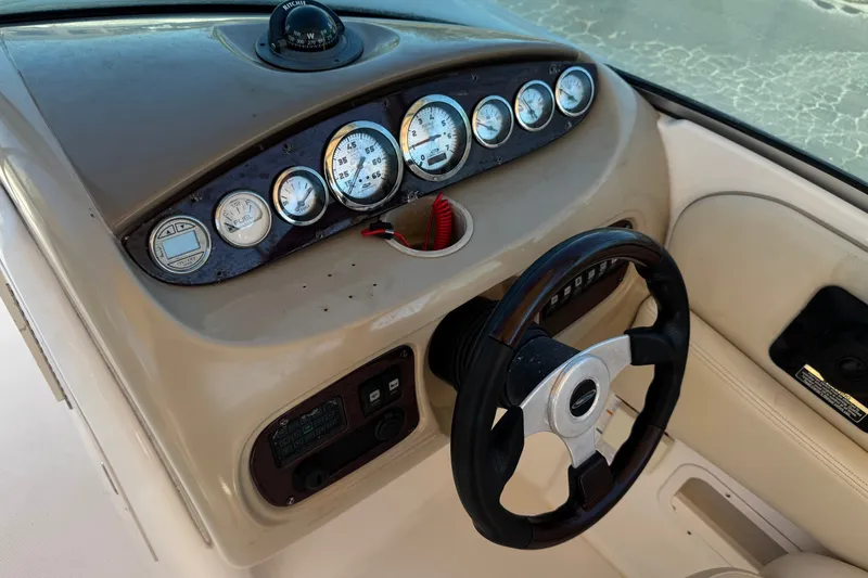 Slide: The Image of Dashboard and steering wheel of a 2003 Chaparral Sunesta 263 boat. - 35