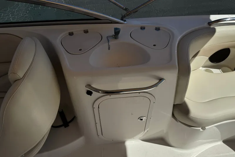 Slide: The Image of 2003 Chaparral Sunesta 263 boat interior with sink and seating area. - 26