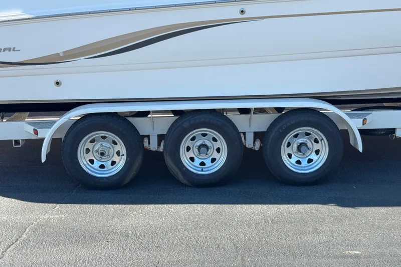 Slide: The Image of 2003 Chaparral Sunesta 263 boat on a triple-axle trailer, side view. - 38