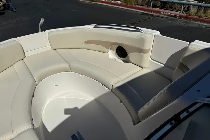 Slide: The Image of 2003 Chaparral Sunesta 263 boat interior with beige seating and cup holder. - 15