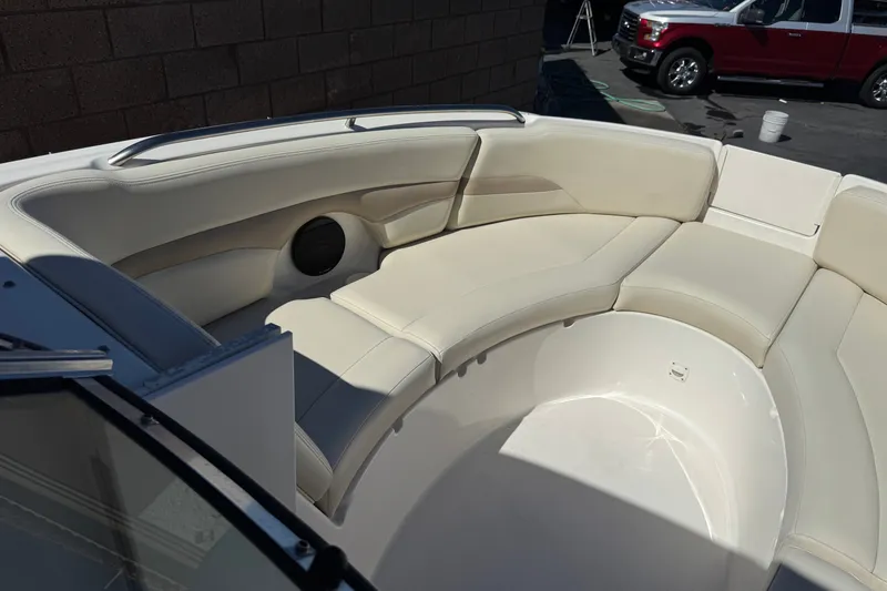 Slide: The Image of 2003 Chaparral Sunesta 263 boat interior with cream seating and speaker. - 14