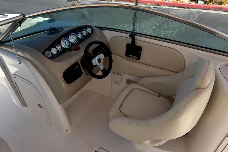 Slide: The Image of 2003 Chaparral Sunesta 263 boat cockpit with steering wheel and instrument panel. - 33