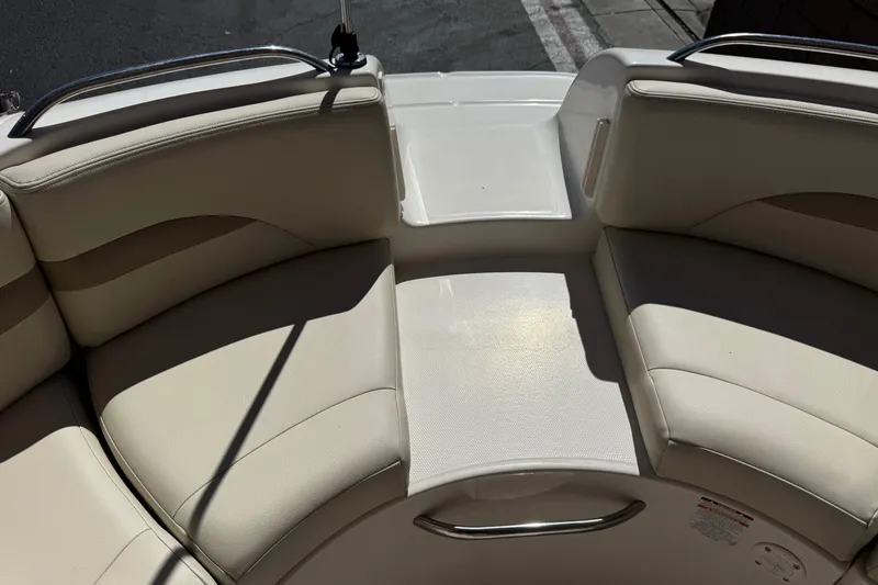 Slide: The Image of 2003 Chaparral Sunesta 263 boat interior with beige seating and stainless steel railings. - 23