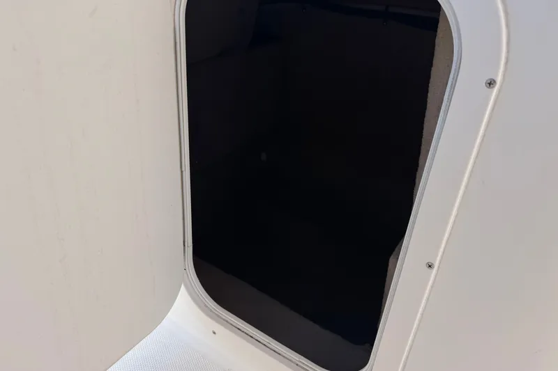 Slide: The Image of Open storage compartment on a 2003 Chaparral Sunesta 263 boat. - 37