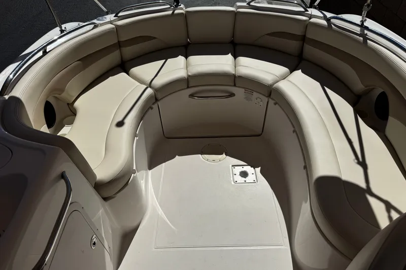 Slide: The Image of 2003 Chaparral Sunesta 263 boat interior with beige seating and spacious layout. - 19
