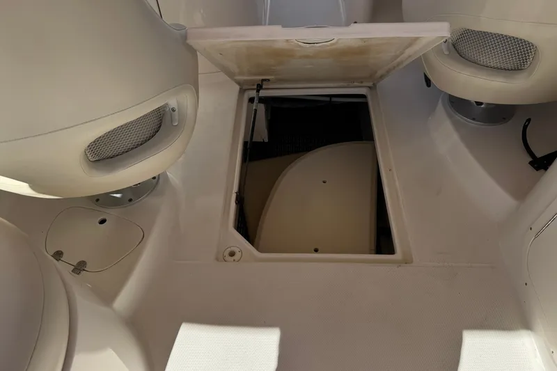 Slide: The Image of 2003 Chaparral Sunesta 263 boat interior with open storage compartment. - 25
