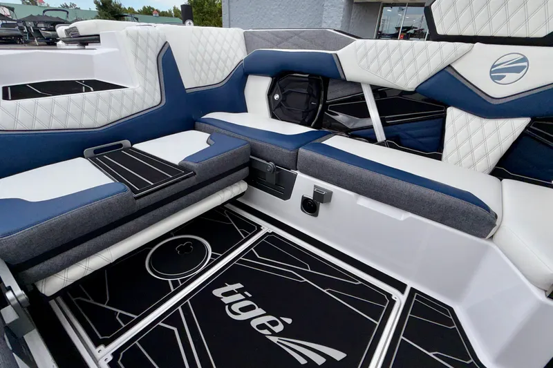 Slide: The Image of 2027 Tigé 24RZX boat interior with blue and white seating, modern design. - 27