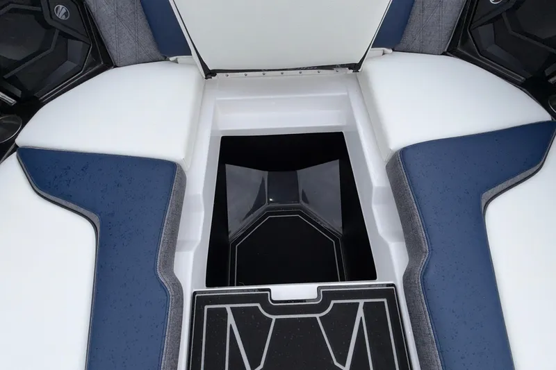 Slide: The Image of 2027 Tigé 24RZX boat interior storage compartment with blue and white seating. - 45