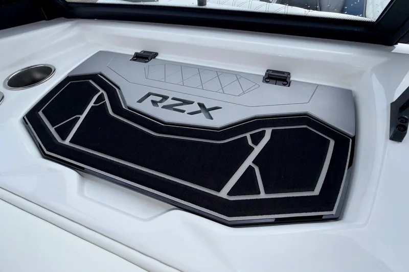 Slide: The Image of 2027 Tigé 24RZX boat interior with RZX logo and sleek design. - 33