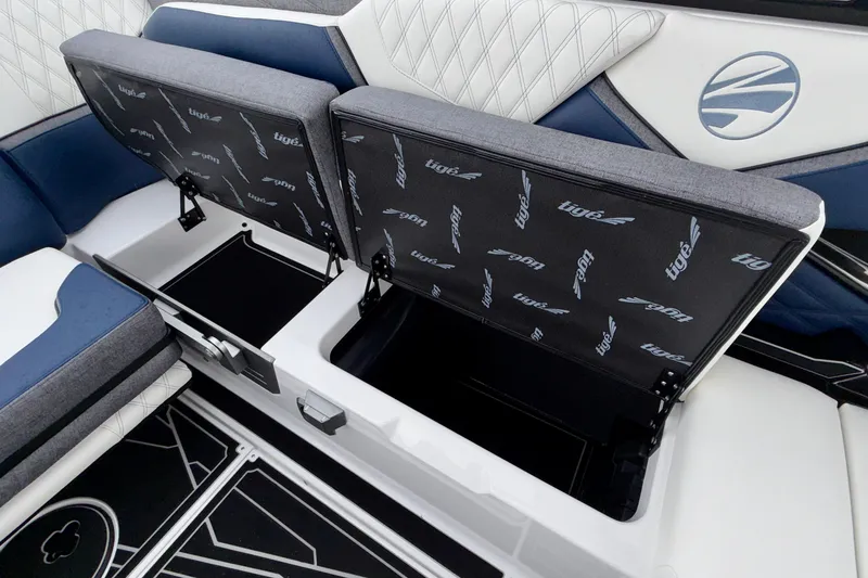 Slide: The Image of 2027 Tigé 24RZX boat interior with open storage compartments and stylish seating. - 41
