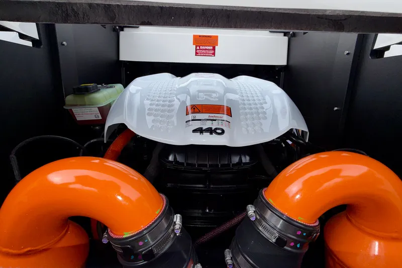Slide: The Image of Engine compartment of 2027 Tigé 24RZX boat with orange hoses and Indmar 440 engine. - 19