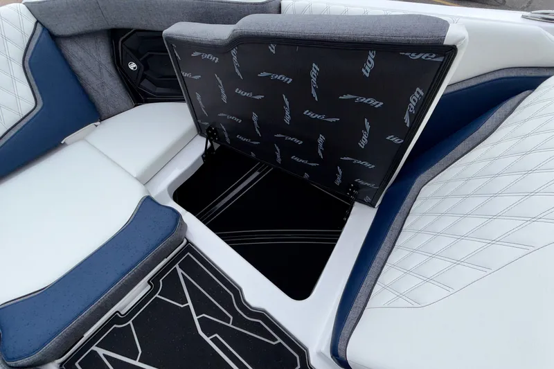 Slide: The Image of 2027 Tigé 24RZX boat interior with open storage compartment and stylish seating. - 44