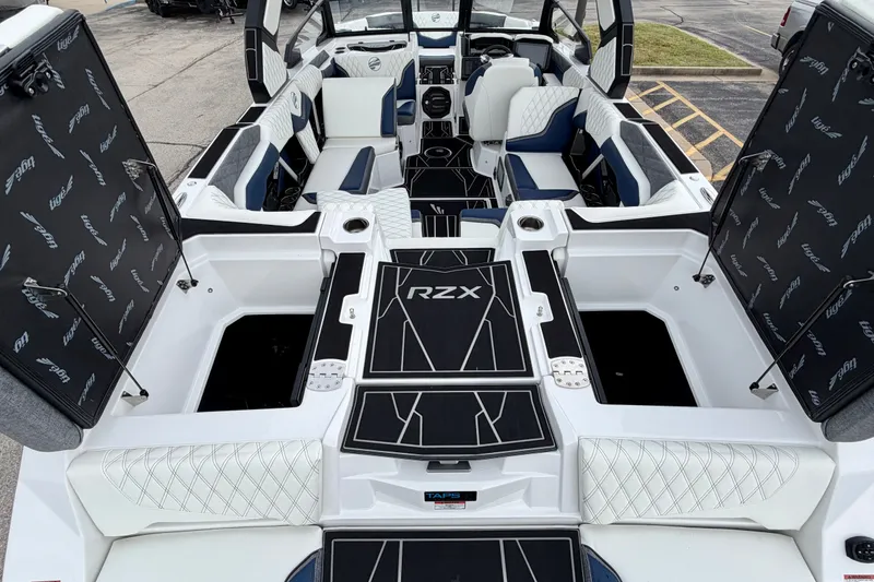 Slide: The Image of 2027 Tigé 24RZX boat interior with open storage compartments and luxury seating. - 17