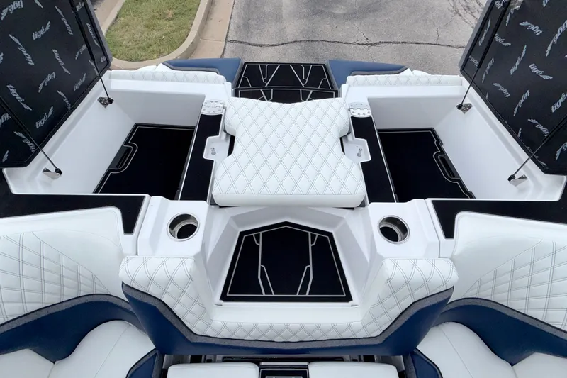 Slide: The Image of 2027 Tigé 24RZX boat interior with white quilted seats and storage compartments. - 16