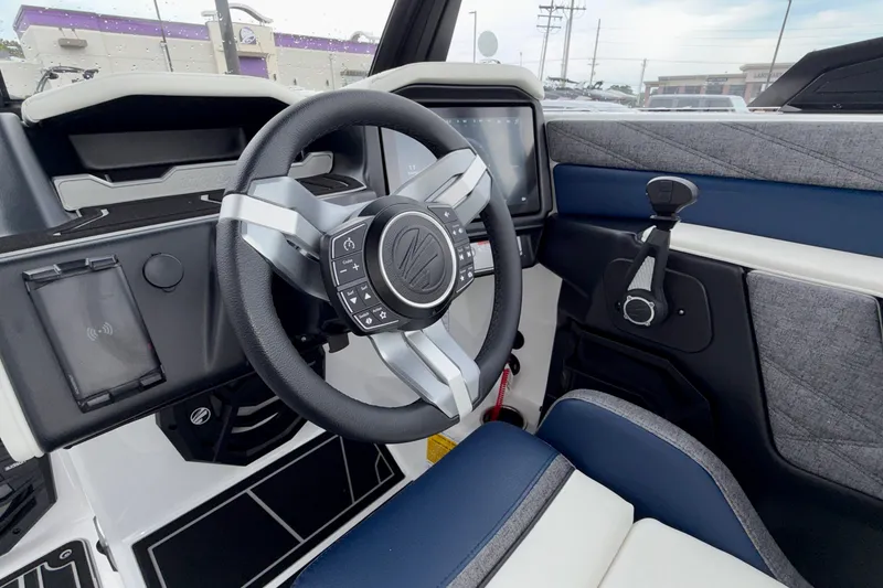 Slide: The Image of 2027 Tigé 24RZX boat interior with modern steering wheel and dashboard controls. - 38