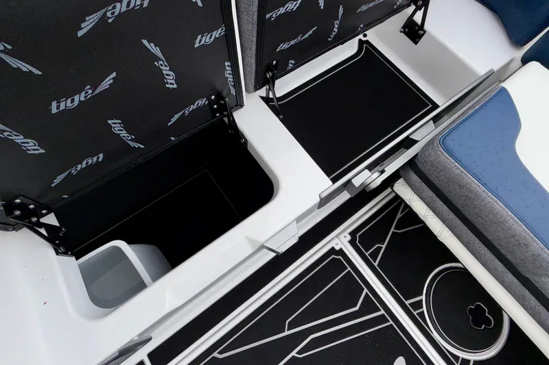 Slide: The Image of 2027 Tigé 24RZX boat interior storage compartments with branded upholstery and sleek design. - 42