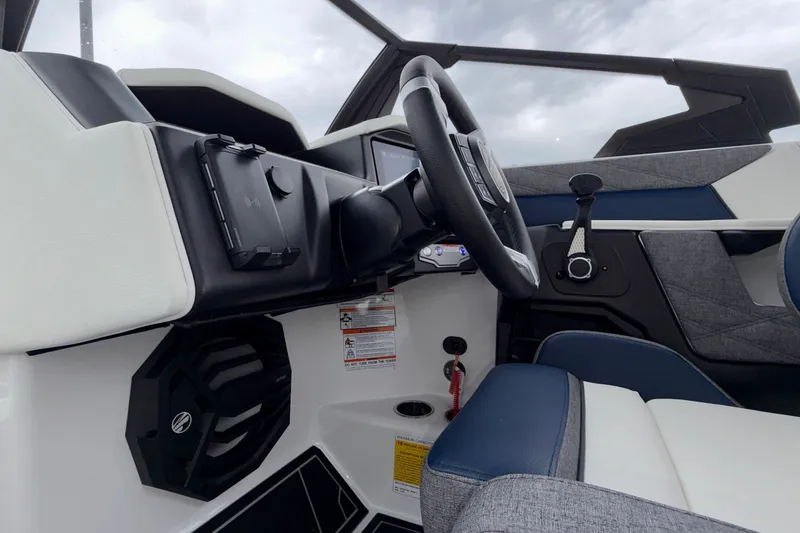 Slide: The Image of Interior view of 2027 Tigé 24RZX boat cockpit with steering wheel and modern controls. - 40