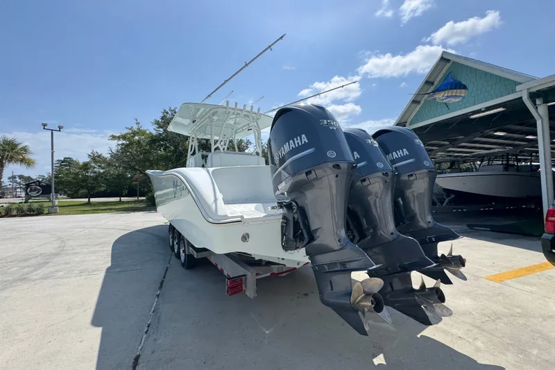 Slide: The Image of 2014 Yellowfin 39 Offshore boat with triple Yamaha 350 engines in a sunny marina. - 22