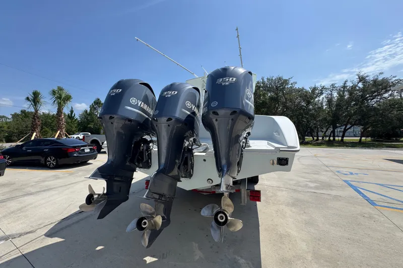 Slide: The Image of 2014 Yellowfin 39 Offshore boat with triple Yamaha 350 V8 engines in a parking lot. - 19