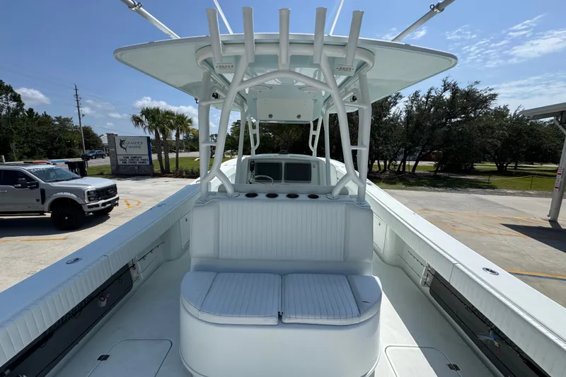 Slide: The Image of 2014 Yellowfin 39 Offshore boat with spacious deck and seating, parked outdoors. - 40