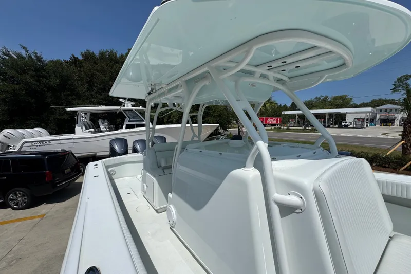 Slide: The Image of 2014 Yellowfin 39 Offshore boat with T-top, parked near other boats and vehicles. - 29