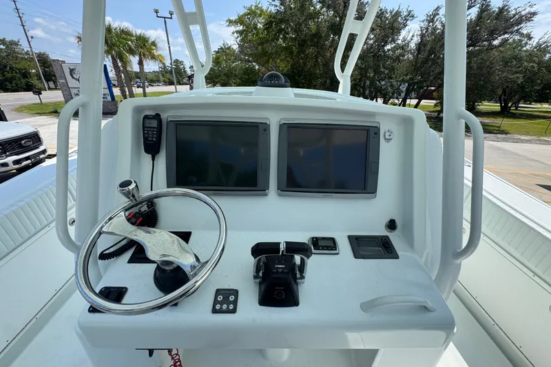 Slide: The Image of 2014 Yellowfin 39 Offshore boat helm with dual screens and steering wheel. - 36