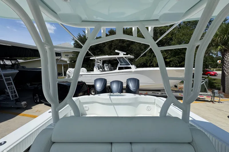 Slide: The Image of 2014 Yellowfin 39 Offshore boat with triple engines, parked outdoors under clear skies. - 33