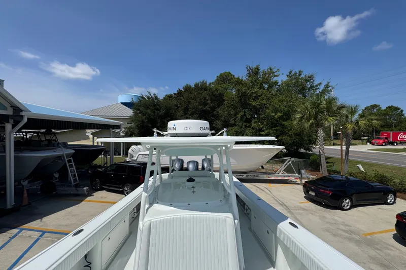 Slide: The Image of 2014 Yellowfin 39 Offshore boat parked at a marina with surrounding vehicles. - 27