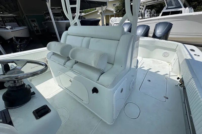 Slide: The Image of 2014 Yellowfin 39 Offshore boat interior with white seating and steering wheel. - 31