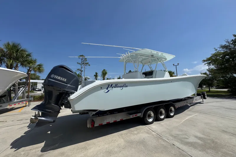 Slide: The Image of 2014 Yellowfin 39 Offshore boat on trailer with Yamaha engine, parked outdoors. - 16