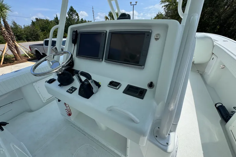 Slide: The Image of 2014 Yellowfin 39 Offshore boat helm with dual screens and steering wheel. - 38
