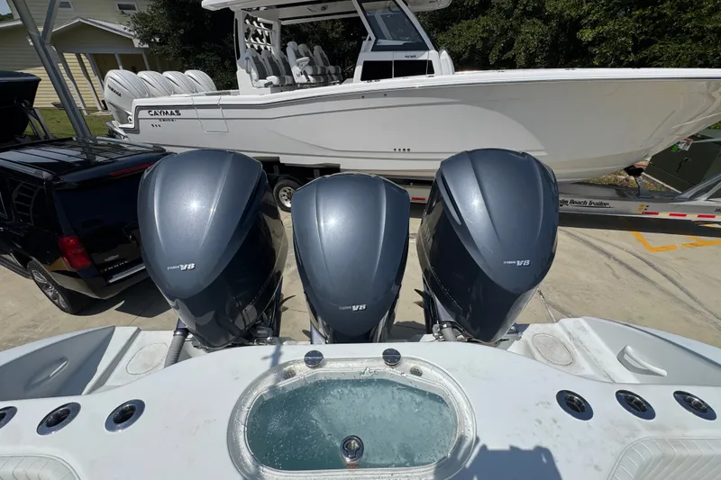 Slide: The Image of 2014 Yellowfin 39 Offshore boat with triple outboard engines, parked on a trailer. - 44