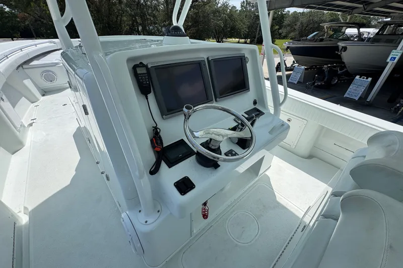 Slide: The Image of 2014 Yellowfin 39 Offshore boat cockpit with dual screens and steering wheel. - 35