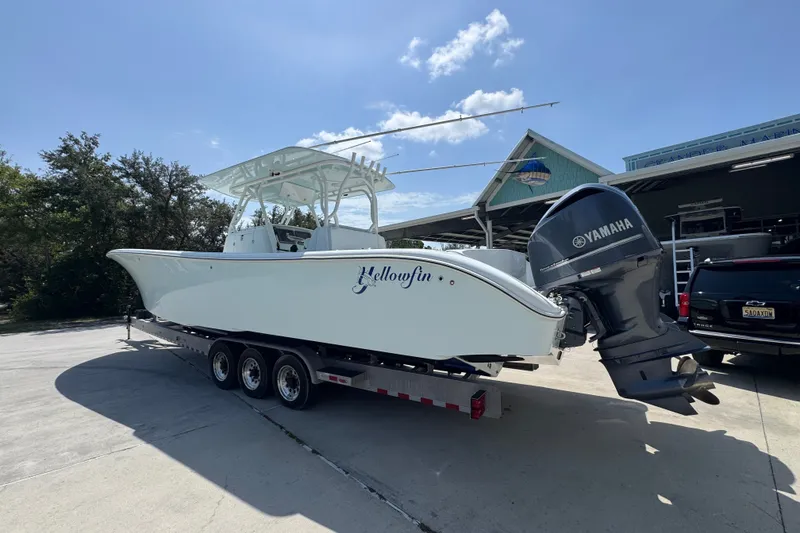 Slide: The Image of 2014 Yellowfin 39 Offshore boat on trailer with Yamaha engine, parked outdoors. - 24