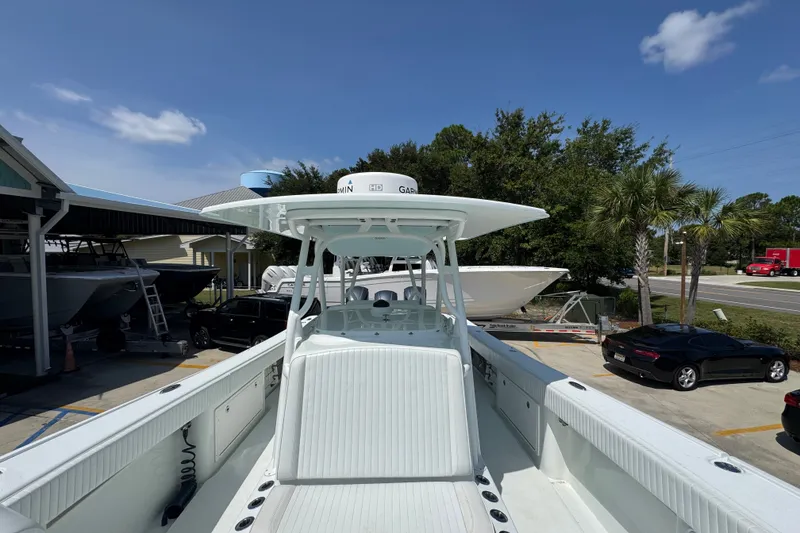 Slide: The Image of 2014 Yellowfin 39 Offshore boat docked, showcasing sleek design and spacious deck. - 26