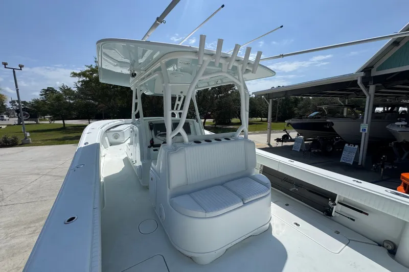 Slide: The Image of 2014 Yellowfin 39 Offshore boat with spacious deck and seating under clear sky. - 39